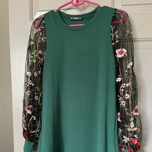 Evergreen dress with sheer long sleeves, with flowers stitched into sleeves